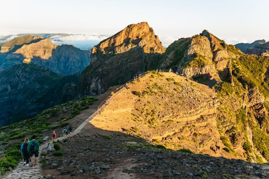 Walkers on the Pico do Arieiro ridge with the cloud layer below them